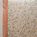 Stuzzi Amber 60cm x 120cm terrazzo effect tiles with a 4D brushed finish, highlighting the detailed mix of warm amber, terracotta, cream and contrasting darker fragments.