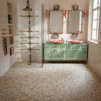 Luxury bathroom featuring Stuzzi Amber 60x60cm classical terrazzo style porcelain floor tiles with a 4D brushed finish, paired with soft blush gloss wall tiles, a sage green vanity unit, pink basins, brushed brass fittings and vintage-inspired details.