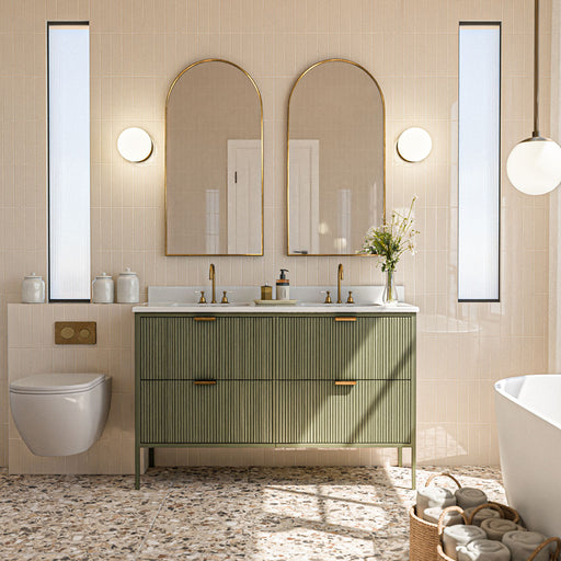 Bathroom featuring Stuzzi Dolmia 60cm x 120cm classical terrazzo-style floor tiles with a 4D brushed finish, paired with neutral wall tiles, a fluted green vanity, brass details and arched mirrors.