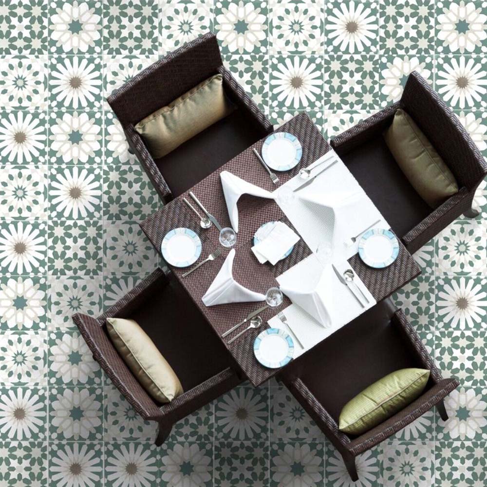 Dining area floor featuring Souk Green A 20×20cm Moroccan-style porcelain tiles arranged in a green and white geometric pattern.