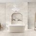 Bathroom interior featuring Taj Mahal Matt 60 × 120cm marble effect porcelain wall and floor tiles, showcasing soft cream tones with gentle, flowing veining. The larger format enhances the sense of space, creating a seamless, spa-like setting complemented by warm wood accents and soft, natural light.