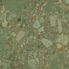 Close-up of Terrazerri Terrazzo Green 60x60cm porcelain tile featuring a terrazzo effect in soft sage green tones. The design combines large and small stone fragments with subtle warm brown flecks, creating a natural, contemporary surface with depth and texture for walls and floors.