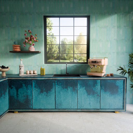 Kitchen featuring Terrazerri Terrazzo Ivory 60cm x 60cm floor tiles in a soft ivory tone, paired with aqua tiled walls, teal cabinetry, dark worktops and a large feature window.