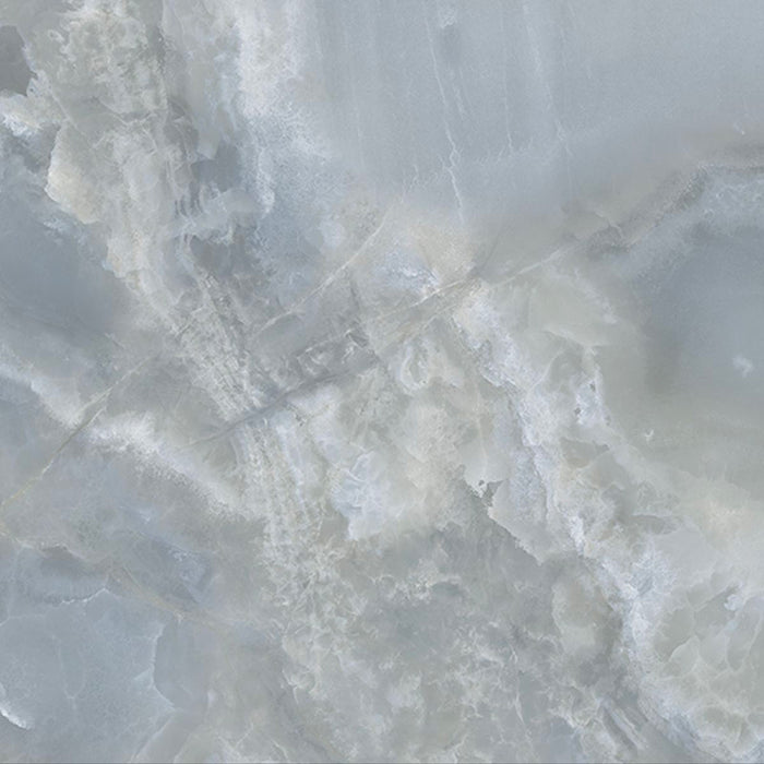 Close-up of Thebes Blue Honed Matt Onyx 60x60cm porcelain tile featuring soft blue onyx-effect veining with layered white, grey and pale blue tones. The honed matt finish creates a luxurious natural stone look, perfect for bathroom walls, feature walls and elegant interiors.