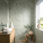 Spa-inspired bathroom featuring Thebes Green matt onyx effect porcelain wall and floor tiles in 60cm x 60cm. Soft green onyx effect tiles create a calming backdrop, complemented by natural wood furniture, fluted green feature tiles and minimalist styling.