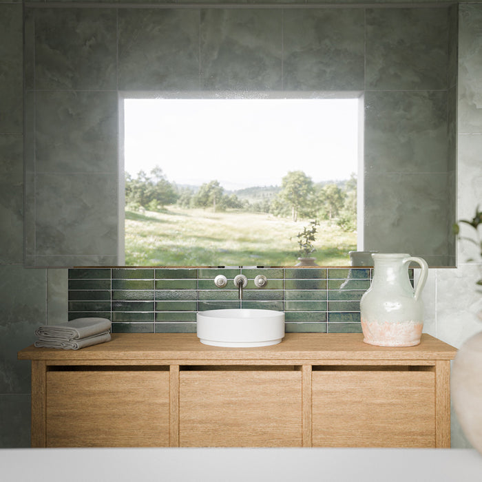 Contemporary bathroom with Thebes Green honed matt onyx effect porcelain wall tiles in 60cm x 60cm. Soft green onyx effect tiles are paired with a glossy green brick tile splashback, warm oak vanity, and minimalist basin to create a calm, nature-inspired bathroom.
