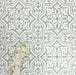 Flat lay of London Streets Thornton Place Sage Green 20cm x 20cm Victorian Moroccan style tiles arranged in a repeating pattern, featuring intricate white motifs on a sage green background with decorative white flowers.