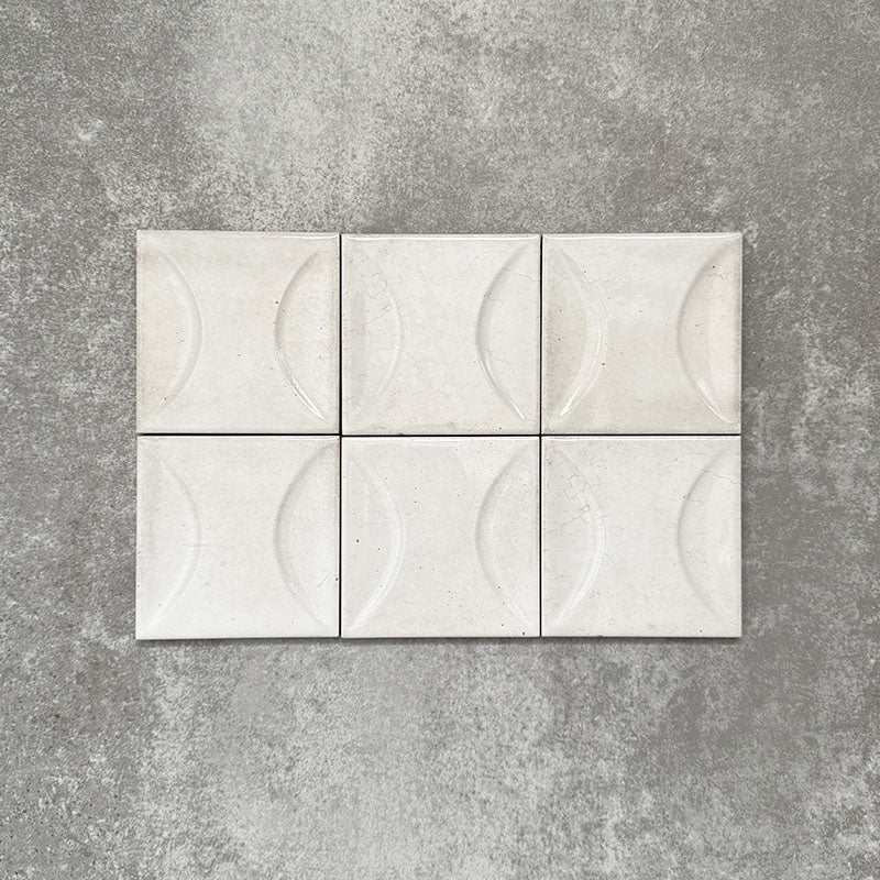 Close-up of Saigon White Decor Square Wall tiles, featuring Moroccan-style 10 × 10cm glossy ceramic tiles in soft white tones with a curved decorative relief pattern.