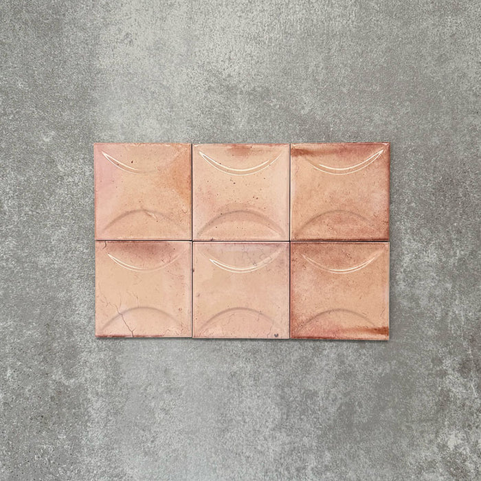 Close-up of Saigon Rose Pink Decor Square Wall tiles, featuring Moroccan-style 10 × 10cm glossy ceramic tiles in soft blush and rose tones with a curved decorative relief pattern.