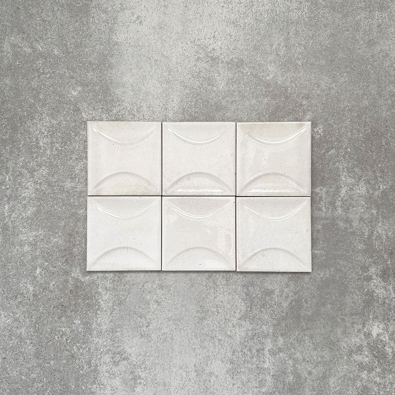 Saigon White Decor Square Wall tiles shown in a grouped layout, featuring Moroccan-style 10 × 10cm glossy ceramic tiles in soft white tones with a curved decorative relief pattern.