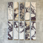 Fayrouz Viola 5x20cm natural marble tiles with a honed finish, featuring a white base with bold burgundy and warm-toned veining, arranged in a neat grid to highlight natural variation and distinctive stone detail.