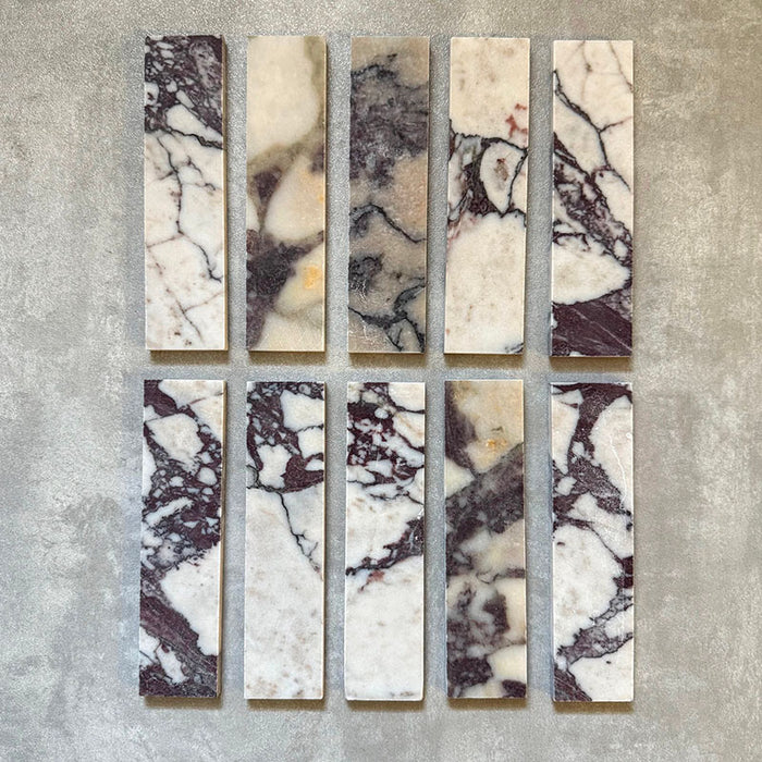 Fayrouz Viola 5x20cm natural marble tiles with a honed finish, featuring a white base with bold burgundy and warm-toned veining, arranged in a neat grid to highlight natural variation and distinctive stone detail.