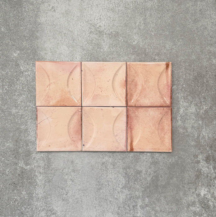 Close-up of Saigon Rose Pink Decor Square Wall tiles, featuring Moroccan-style 10 × 10cm glossy ceramic tiles in soft blush and rose tones with a curved decorative relief pattern.