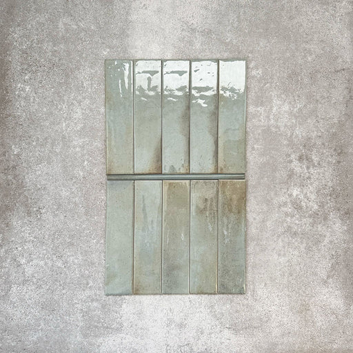 Allegra Celadon Green Gloss pencil bullnose border ceramic tiles in a 1.2 × 30cm format, shown laid vertically to highlight the soft green tones, glossy finish and subtle handmade-style variation, ideal for edging and decorative borders.