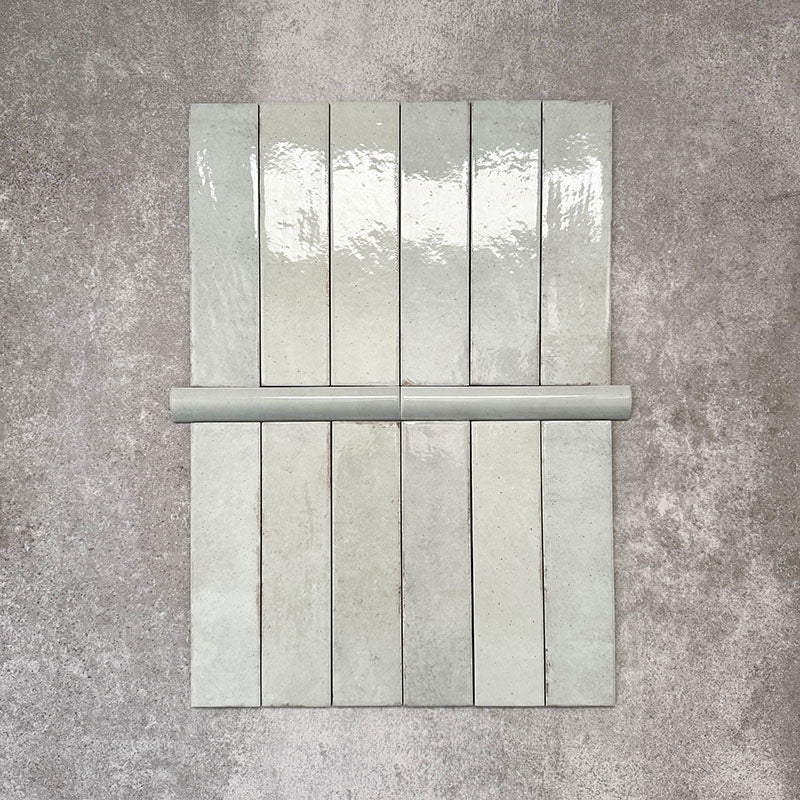 Nomad Mint Green bullnose pencil border ceramic tiles in a 3 × 20cm format, shown with matching brick tiles to highlight the coordinating colour, gloss finish and rounded edge detail.