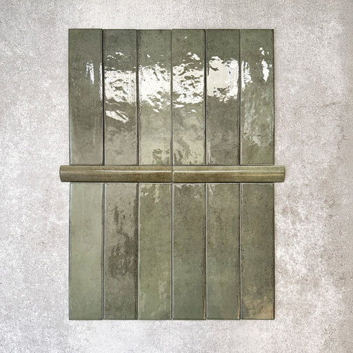 Nomad Sage Green bullnose pencil border ceramic tiles in a 3 × 20cm format, with a glossy finish and subtle tonal variation, designed to create a smooth, decorative edge or trim for coordinating brick wall tiles.