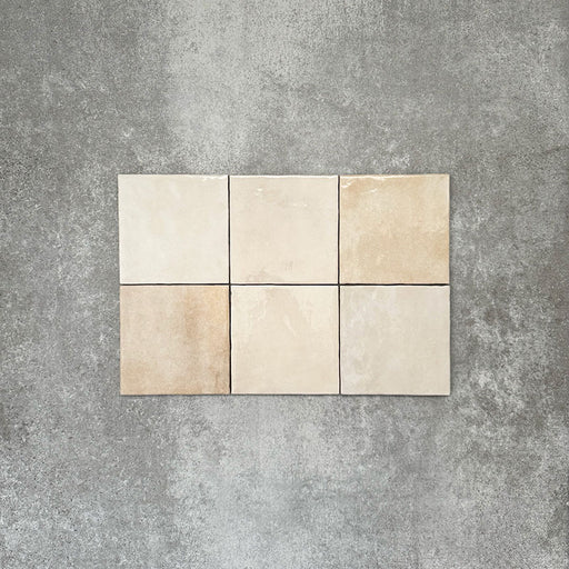 Zellige Bone square tiles laid in a simple grid, featuring a glossy white finish with subtle tonal variation and softly uneven edges.