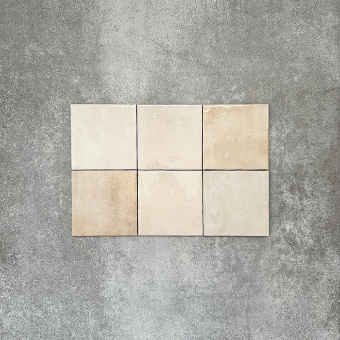 Zellige Bone square tiles laid in a simple grid, featuring a glossy white finish with subtle tonal variation and softly uneven edges.