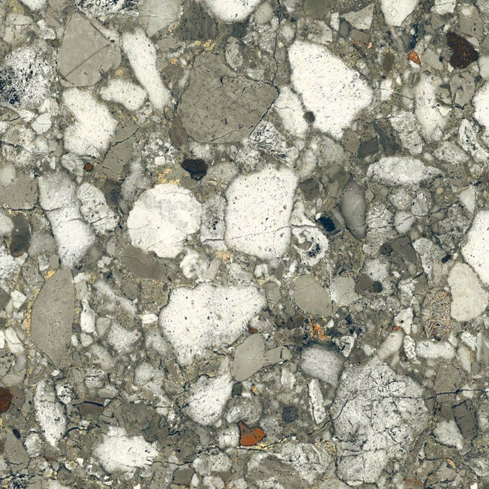 Close-up of Venice Emerald matt terrazzo effect porcelain tile, featuring a rich green-grey base with oversized marble chips and natural stone detailing, ideal for contemporary kitchen, bathroom and living room floors.
