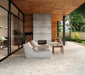 Covered outdoor patio featuring Venice Ivory matt terrazzo effect porcelain tiles in a 60 x 120cm format, creating a seamless indoor-outdoor look with soft ivory tones, contemporary furnishings and a modern fireplace.