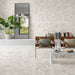 Contemporary living space featuring Venice Ivory polished terrazzo effect porcelain wall and floor tiles, showcasing soft ivory tones with natural stone chips, paired with modern furniture and greenery for a bright, elegant interior.