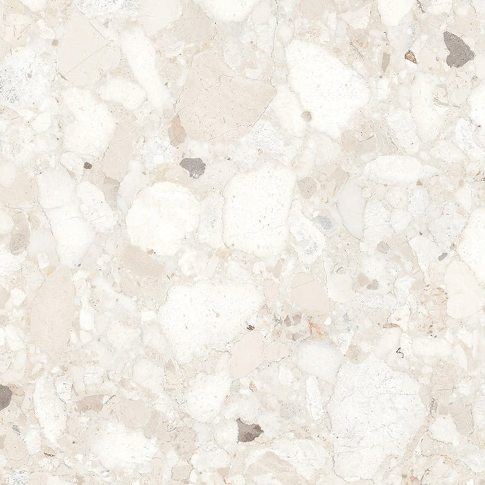 Close-up of Venice Ivory polished terrazzo effect porcelain tile, featuring soft ivory and cream tones with natural stone chips and a polished finish, ideal for luxurious kitchen, bathroom and living room walls and floors.