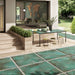 Outdoor patio featuring Verde Copper Oxide 2cm thick porcelain floor tiles in a metallic effect finish, styled with contemporary garden furniture, timber-effect steps, built-in planters and modern landscaping for a luxurious outdoor living space.