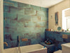 Contemporary bathroom featuring Verde Copper Oxide 30cm x 60cm metallic effect wall and floor tiles, styled with a built-in bath, brass shower fittings and rich blue-green tones for a luxurious interior.