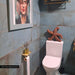 Bathroom featuring Verde Copper Oxide 30cm x 60cm metallic effect wall tiles, styled with brass shower fittings, a wall-mounted basin, wooden shelf and warm contemporary décor.