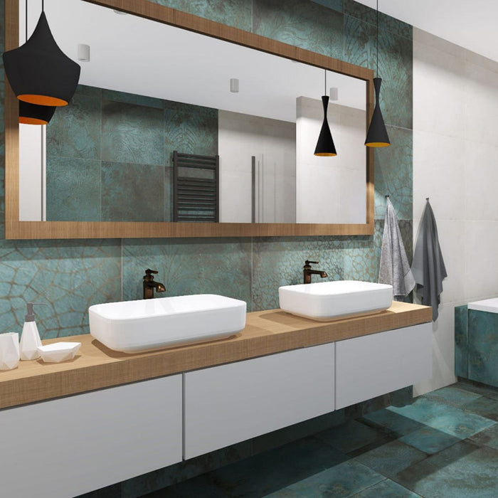 Modern bathroom featuring Verde Patterns Copper Oxide 60cm x 60cm metallic effect porcelain wall and floor tiles, paired with a floating double vanity, timber-framed mirror, black pendant lights and contemporary styling.