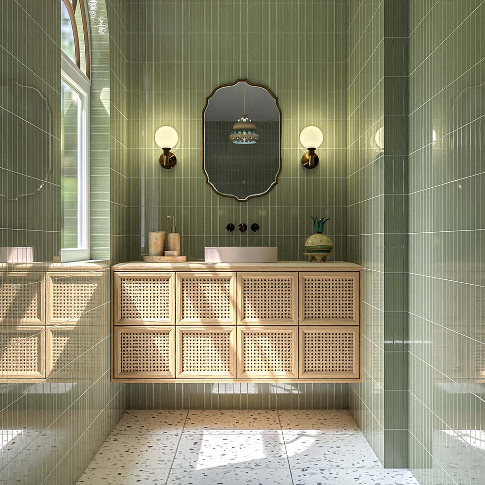 Modern bathroom with Verona Medium Sand terrazzo concrete effect porcelain floor tiles in 60cm x 60cm. Soft terrazzo style flooring complements glossy green textured wall tiles, a floating rattan vanity, warm wood accents, and brass fittings for a calm, contemporary space.