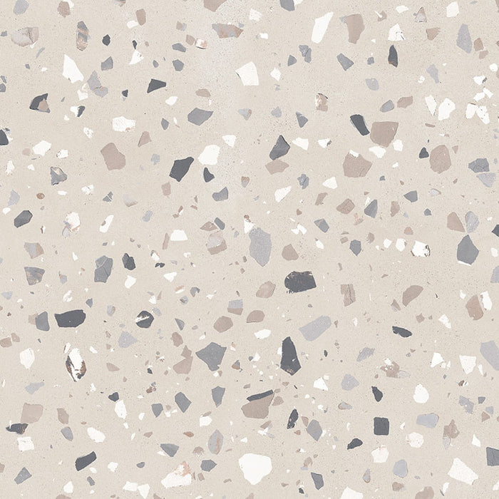 Close-up of Verona Medium Sand concrete effect porcelain tile featuring a warm sand-coloured terrazzo-inspired surface with medium-sized grey, taupe and white stone fragments, creating a timeless contemporary finish for walls and floors.