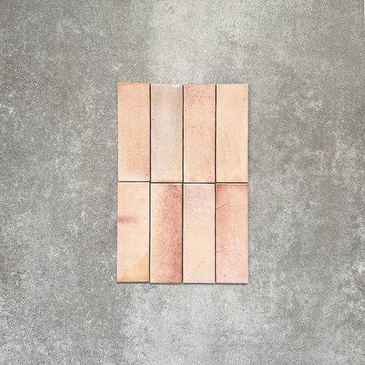 Close-up of Saigon Rose Pink Brick Wall tiles in a Moroccan-style design, 5.1 × 16.1cm glossy ceramic tiles with soft blush and rose colour variation, shown laid vertically.