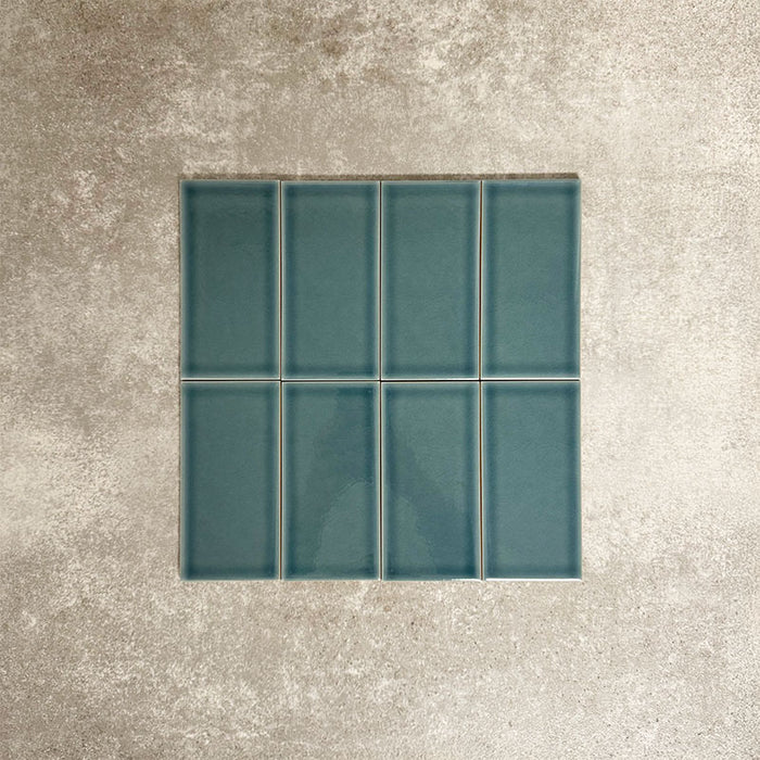 Close-up of Pimlico River Blue 7.5 × 15cm ceramic tiles with a crackle glaze finish, highlighting rich blue tones, subtle surface texture and a classic rectangular format for wall applications.