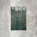 Flat lay of Zellige Royal Green Brick 6.5 × 20cm Moroccan-style ceramic tiles in rich deep green tones, arranged in a vertical brick layout on a textured grey background, showcasing the glossy glaze, natural tonal variation and handcrafted zellige-effect finish.