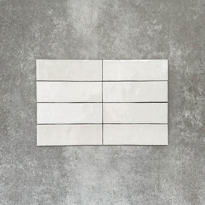 Zellige White brick tiles in a 6.5 × 20cm format, shown in a clean white gloss with subtle surface variation.