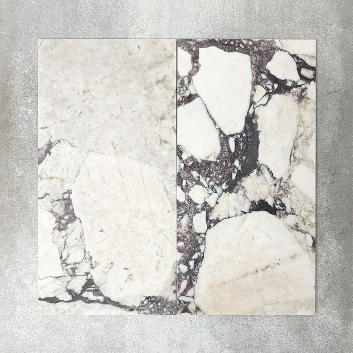 Close-up of Fayrouz Viola natural marble tiles in a honed finish, 30.5x61cm format, showcasing a soft white base with dramatic violet and deep grey veining, creating a bold yet refined look for wall and floor applications.