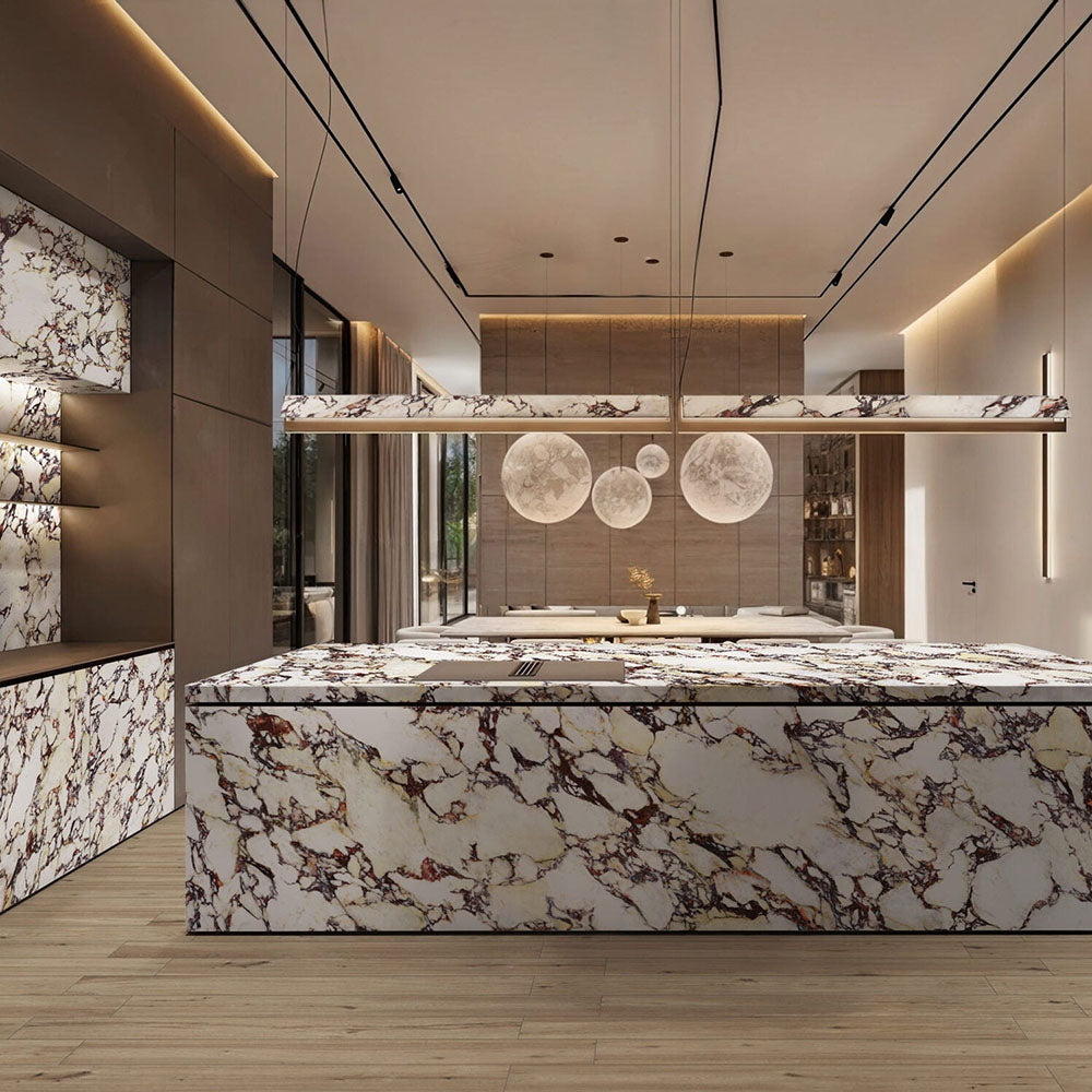 Kitchen interior featuring Viola Polished Marble effect 60 × 120cm porcelain wall and floor tiles, styled across a large island and feature surfaces, highlighting bold burgundy veining and a high-gloss finish.