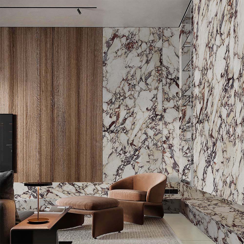 Living area featuring Viola Polished Marble effect 60 × 60cm porcelain wall and floor tiles, styled with warm wood panelling, leather seating, and soft furnishings, highlighting dramatic veining and a high-gloss finish.