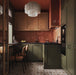 Kitchen featuring Viscount Heythrop 20x20cm Victorian-style wall and floor tiles in warm brown and cream tones, styled with olive green cabinetry, terracotta wall tiles, dark wood finishes, and ambient lighting.