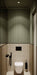 Bathroom featuring Viscount Park Road 20x20cm Victorian-style wall and floor tiles, paired with vertical olive wall panelling, wood-effect surfaces, and matte black fixtures for a refined contemporary interior.
