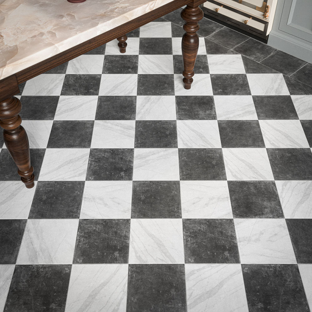 Vitoria Antique Black 30cm x 30cm marble effect chequerboard tiles, featuring a deep charcoal finish paired with white marble effect tiles to create a classic checkerboard floor, framed with a coordinating dark border.