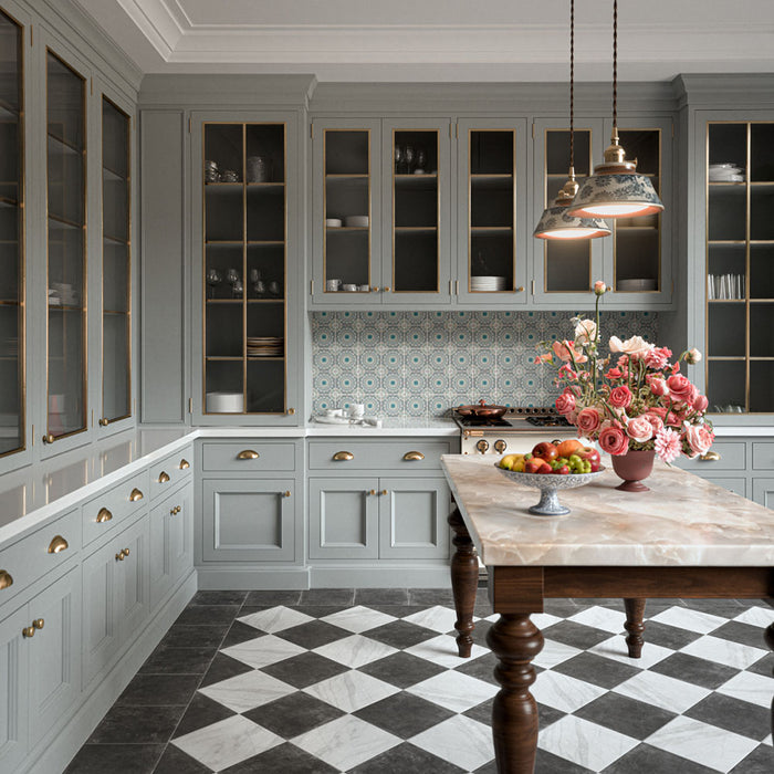 Vitoria Antique White 30cm x 30cm marble effect chequerboard tiles, creating a classic black and white kitchen floor, paired with soft grey cabinetry, brass details and a statement marble island.