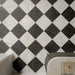 Vitoria Classic Bianco White 30cm x 30cm marble effect tiles, arranged in a classic black and white chequerboard pattern with delicate veining for an elegant, timeless floor.