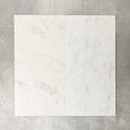 Close-up of Fayrouz White natural marble tiles in a honed finish, 30.5x61cm format, showcasing a soft white base with subtle grey veining and gentle tonal variation, creating a refined and timeless look for wall and floor applications.