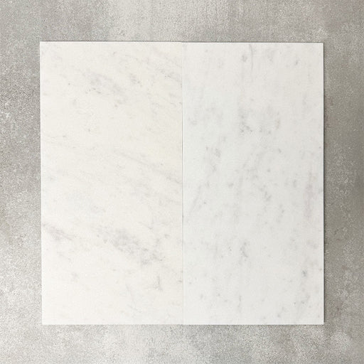 Close-up of Fayrouz White natural marble tiles in a honed finish, 30.5x61cm format, showcasing a soft white base with subtle grey veining and gentle tonal variation, creating a refined and timeless look for wall and floor applications.