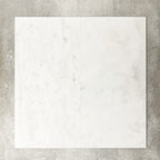 Close-up of Fayrouz White natural marble tiles in a honed finish, 30.5x61cm format, showcasing a soft white base with subtle grey veining and gentle tonal variation, creating a refined and timeless look for wall and floor applications.