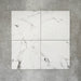 Four Florence Calacatta White 25x25cm marble-effect porcelain tiles displayed together, highlighting the subtle variation in grey veining and the clean, elegant white marble-look finish.