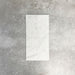 Fayrouz White 5x20cm natural marble tiles with a honed finish, featuring a soft white base with subtle grey veining, arranged in a neat grid to highlight natural variation and tonal consistency.