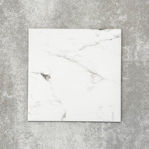 Close-up of Florence Calacatta White 25x25cm marble-effect porcelain tile, featuring a crisp white base with soft grey veining and a smooth, natural marble-look finish.